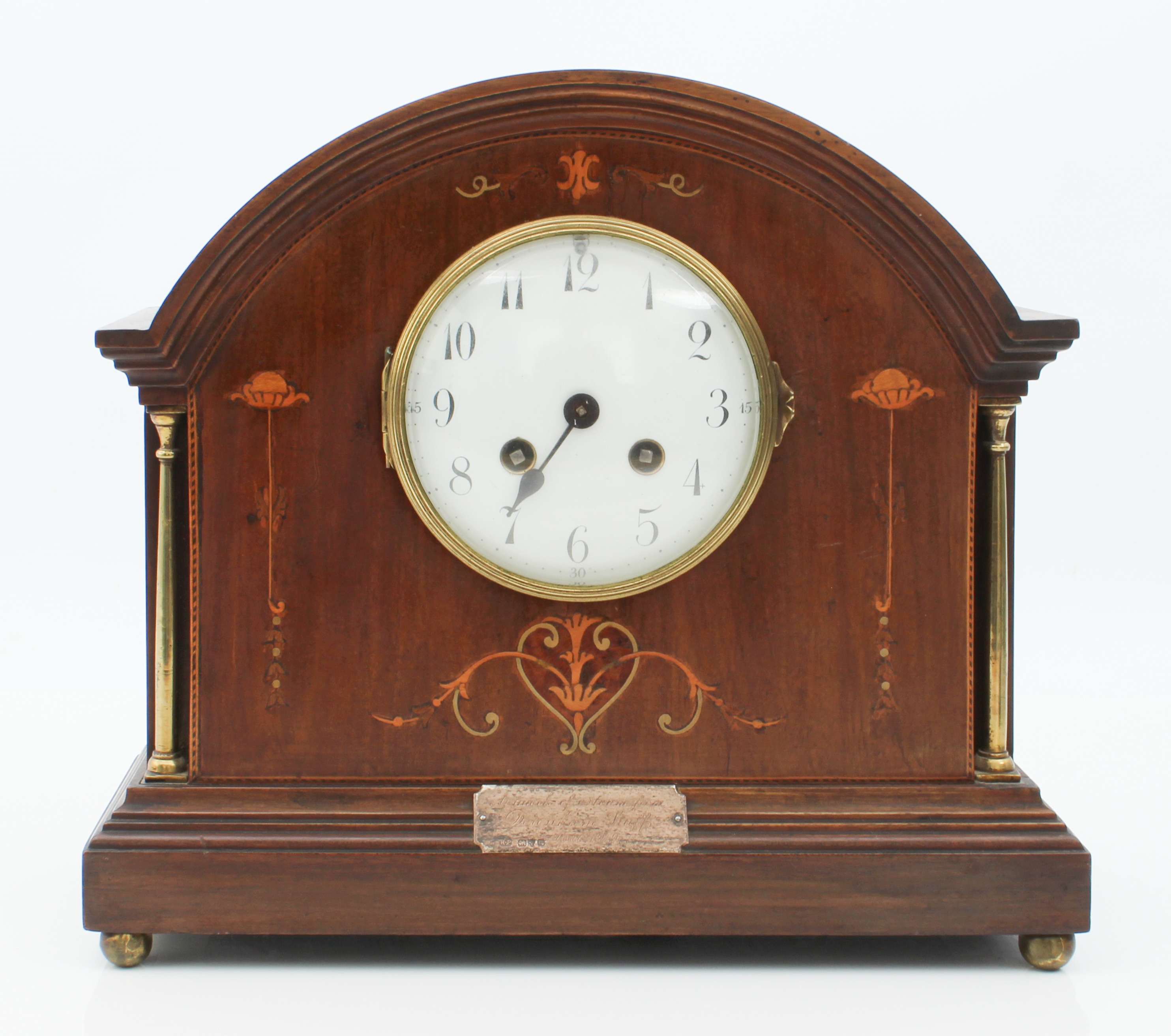 An early 20th century mahogany and marquetry cased mantel clock - the arched case with marquetry