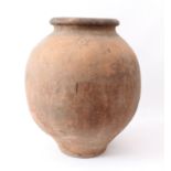 A large terracotta olive jar - with rolled rim and impressed wrigglework decoration to the neck,