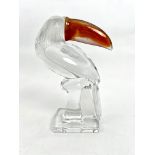 A Daum Crystal glass figure of a toucan - in clear glass with a frosted glass head with amber