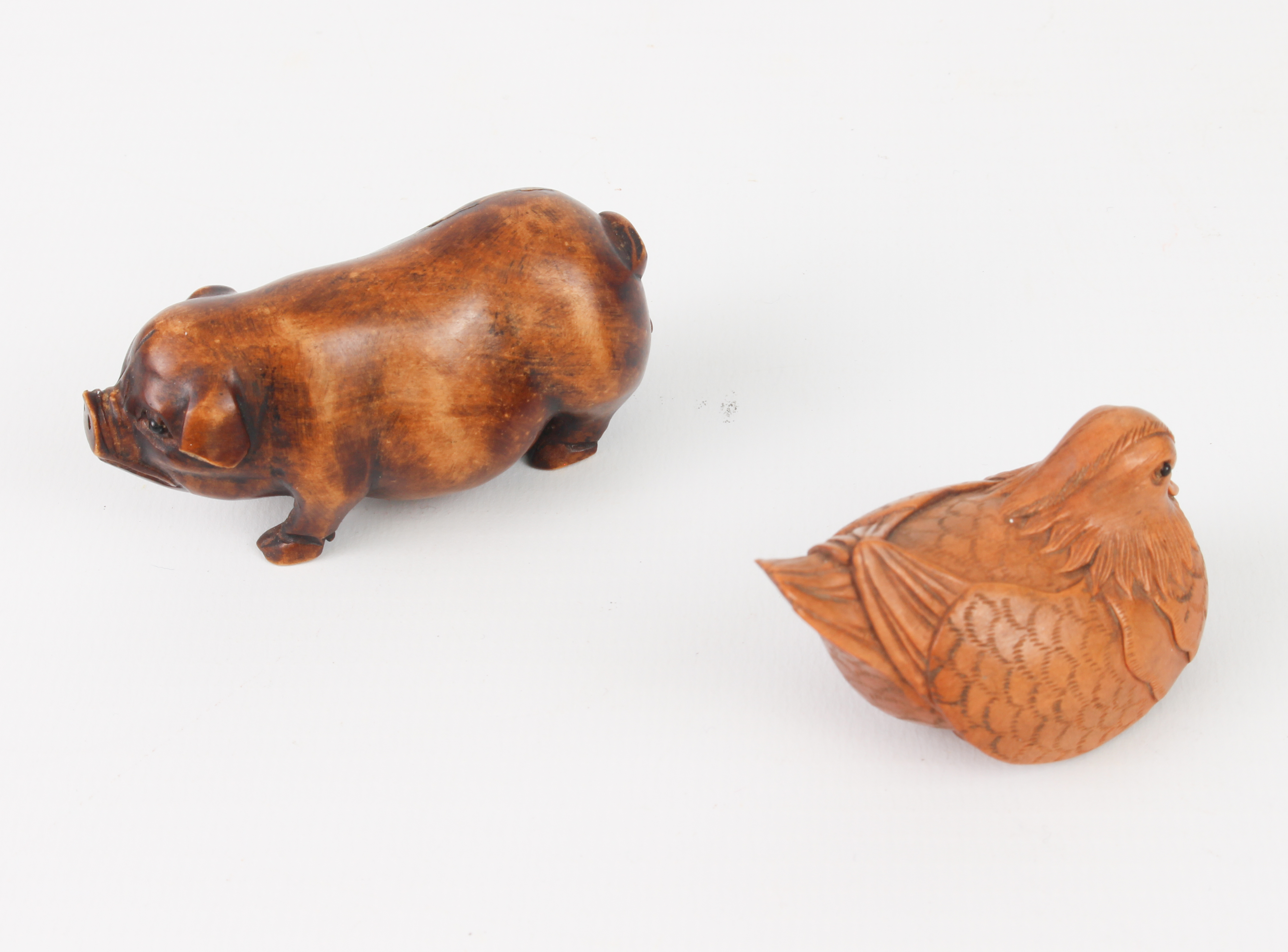 A carved fruitwood Okimono of a pig, plus a carved and signed netsuke of a Mandarin duck. - Image 2 of 3