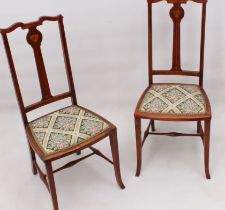 A pair of Edwardian Art Nouveau style inlaid beech wood bedroom chairs - the backs with floral