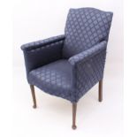 A late 19th century armchair - the serpentine back over roll-top arms, upholstered in dark-blue