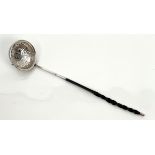 A Georgian white metal toddy ladle - unmarked, the circular bowl with repoussé flowerhead decoration