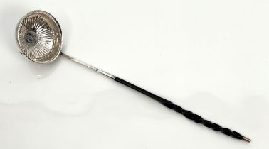 A Georgian white metal toddy ladle - unmarked, the circular bowl with repoussé flowerhead decoration