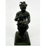 A small grand tour style bronze figure of a seated satyr - probably early 20th century, holding a