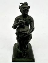 A small grand tour style bronze figure of a seated satyr - probably early 20th century, holding a
