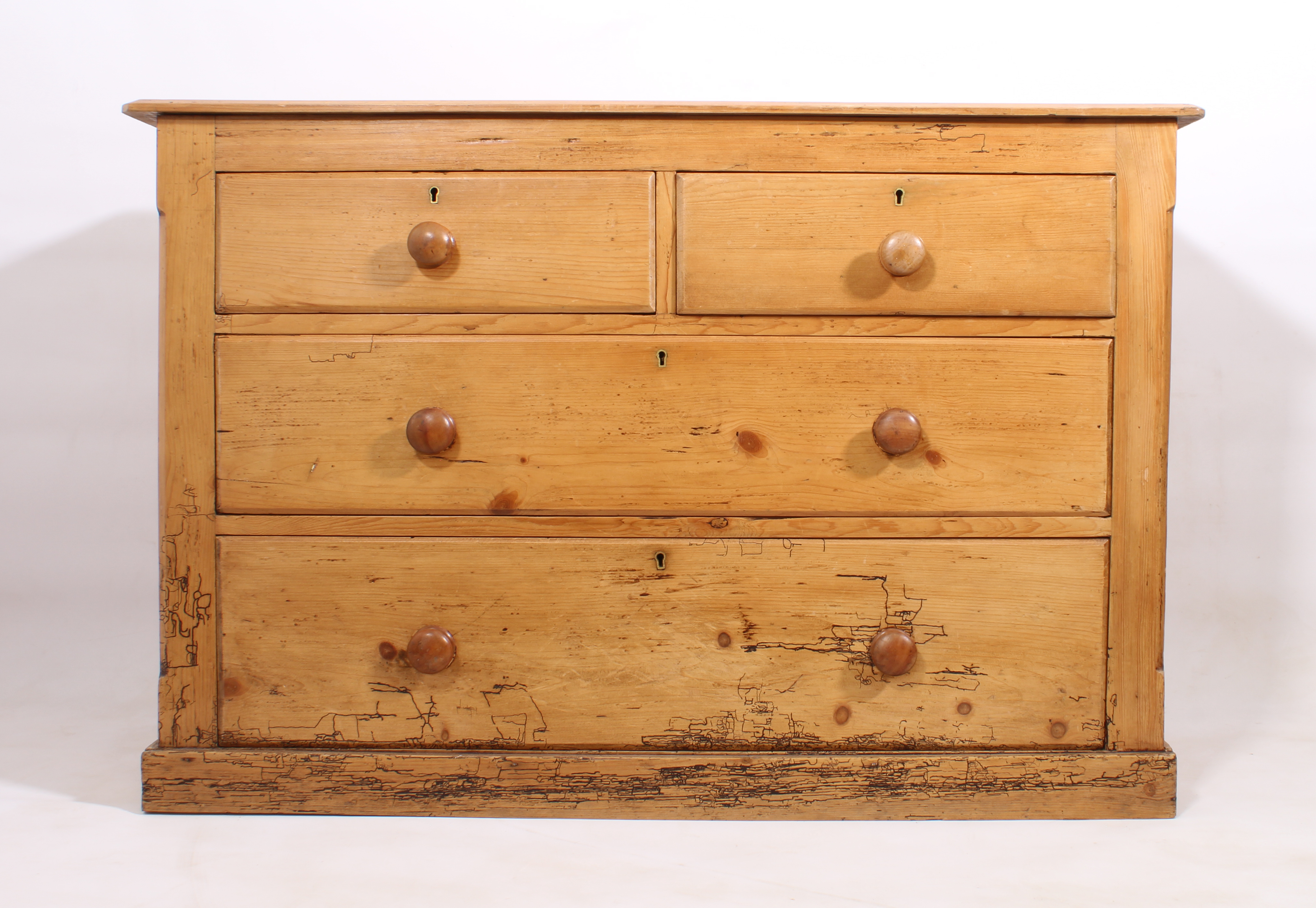 A late-19th century waxed pine chest of drawers - the bevelled top over two short and two long