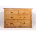 A late-19th century waxed pine chest of drawers - the bevelled top over two short and two long