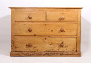 A late-19th century waxed pine chest of drawers - the bevelled top over two short and two long