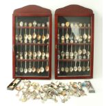 One hundred and twenty-four souvenir teaspoons: 48 contained in two matching display cases and 76