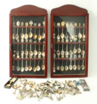 One hundred and twenty-four souvenir teaspoons: 48 contained in two matching display cases and 76