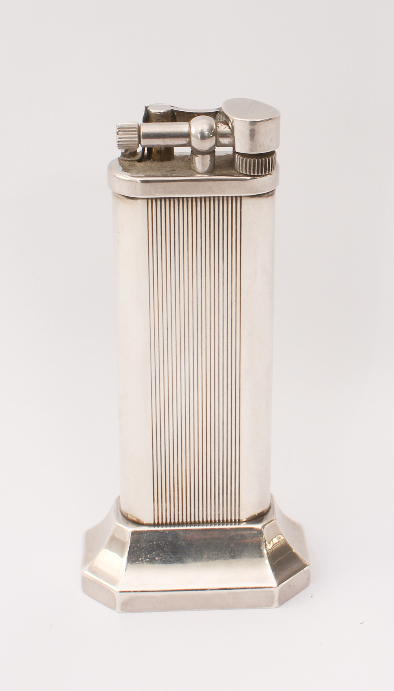 A Dunhill silver-plated tallboy table-lighter - with reeded decoration, on a flared, octagonal base,