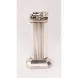 A Dunhill silver-plated tallboy table-lighter - with reeded decoration, on a flared, octagonal base,