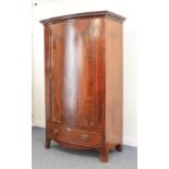 An Edwardian inlaid mahogany bowfront wardrobe - the flared, key carved cornice over a single oval