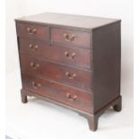 A George III oak straight-front chest of drawers - the moulded top over two short and three long