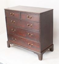 A George III oak straight-front chest of drawers - the moulded top over two short and three long