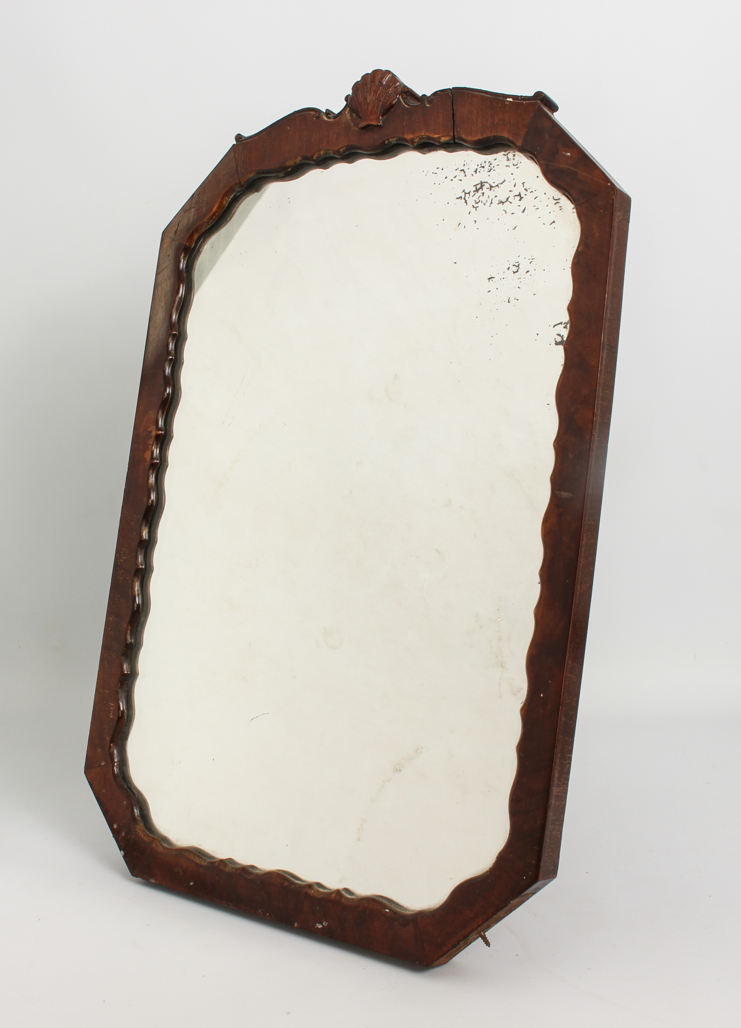 A 1930s octagonal walnut easel back mirror - the frame with serpentine sight edge and shell