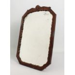 A 1930s octagonal walnut easel back mirror - the frame with serpentine sight edge and shell