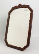 A 1930s octagonal walnut easel back mirror - the frame with serpentine sight edge and shell