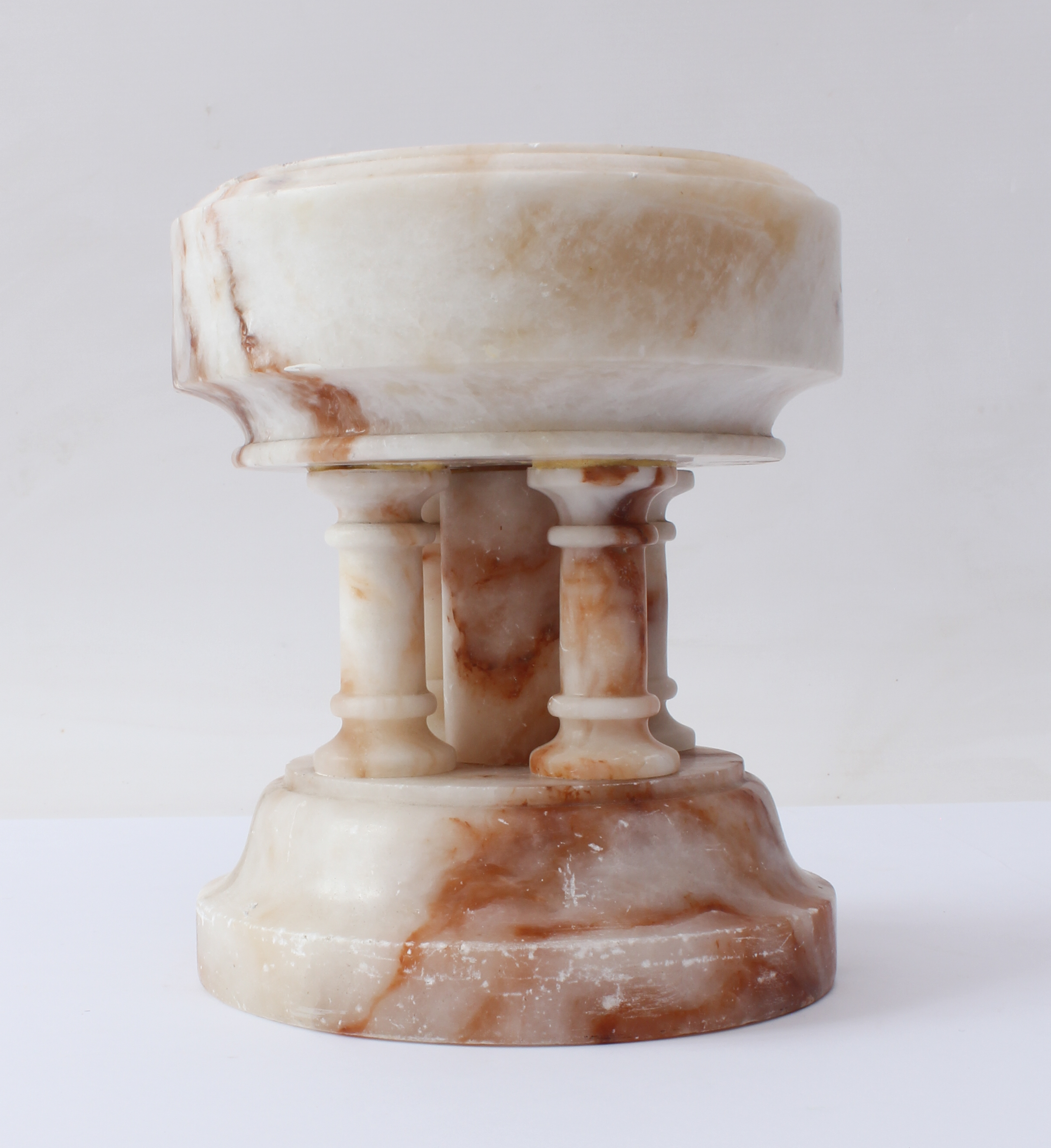 A carved alabaster font - probably first half 20th century, the circular bowl supported on five