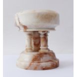 A carved alabaster font - probably first half 20th century, the circular bowl supported on five