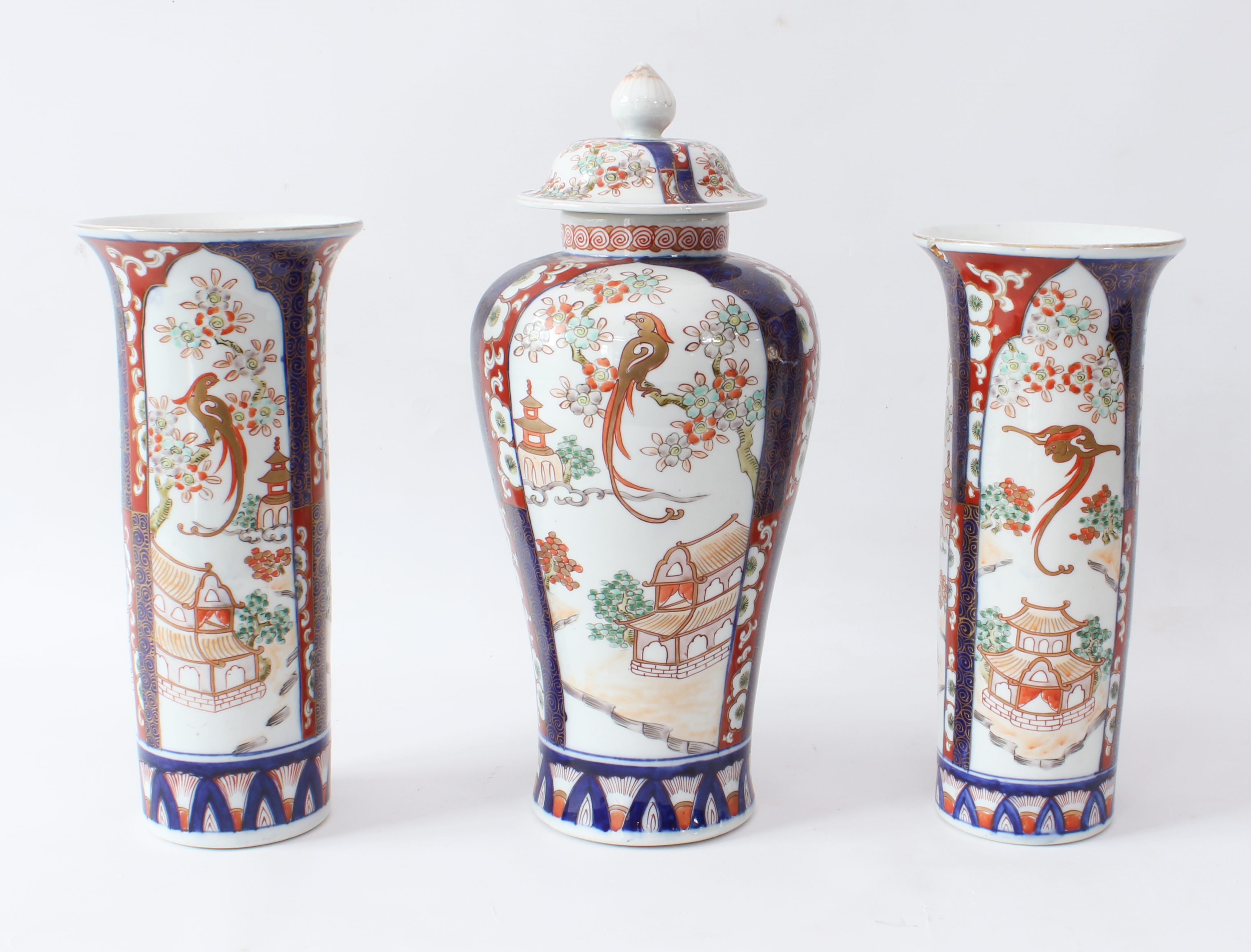 A garniture of three Japanese porcelain Imari decorated vases - early 20th century, comprising a