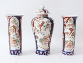 A garniture of three Japanese porcelain Imari decorated vases - early 20th century, comprising a