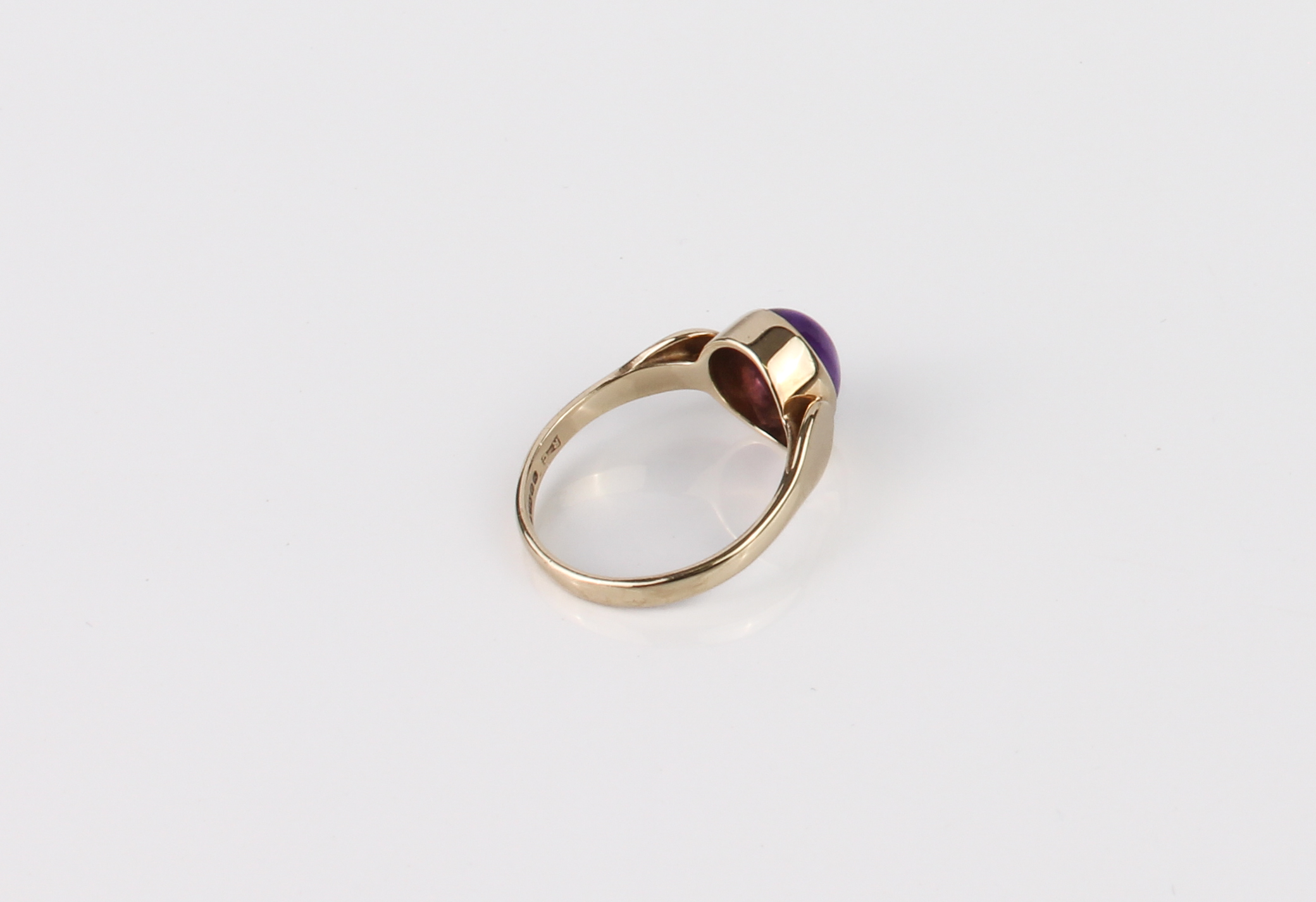 A 9ct gold and amethyst ring - hallmarked Sheffield 1996, the 9 x 7mm cabochon amethyst in a - Image 3 of 4