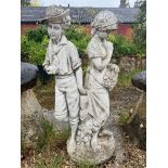 A composite stone garden statue of a girl and boy - 118cm high.