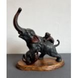 A Japanese bronze figure of an elephant and two tigers in battle after Genryusai Seiya - mid-20th