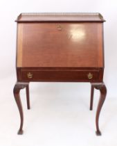 A 1920s mahogany bureau - the top with three-quarter gilt-brass gallery, over a fall front enclosing