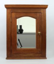 A small mahogany hanging corner cupboard - 2nd half 20th century, with bevelled mirrored door and