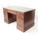 A reproduction mahogany pedestal desk - in the 19th century style, the moulded top with inset