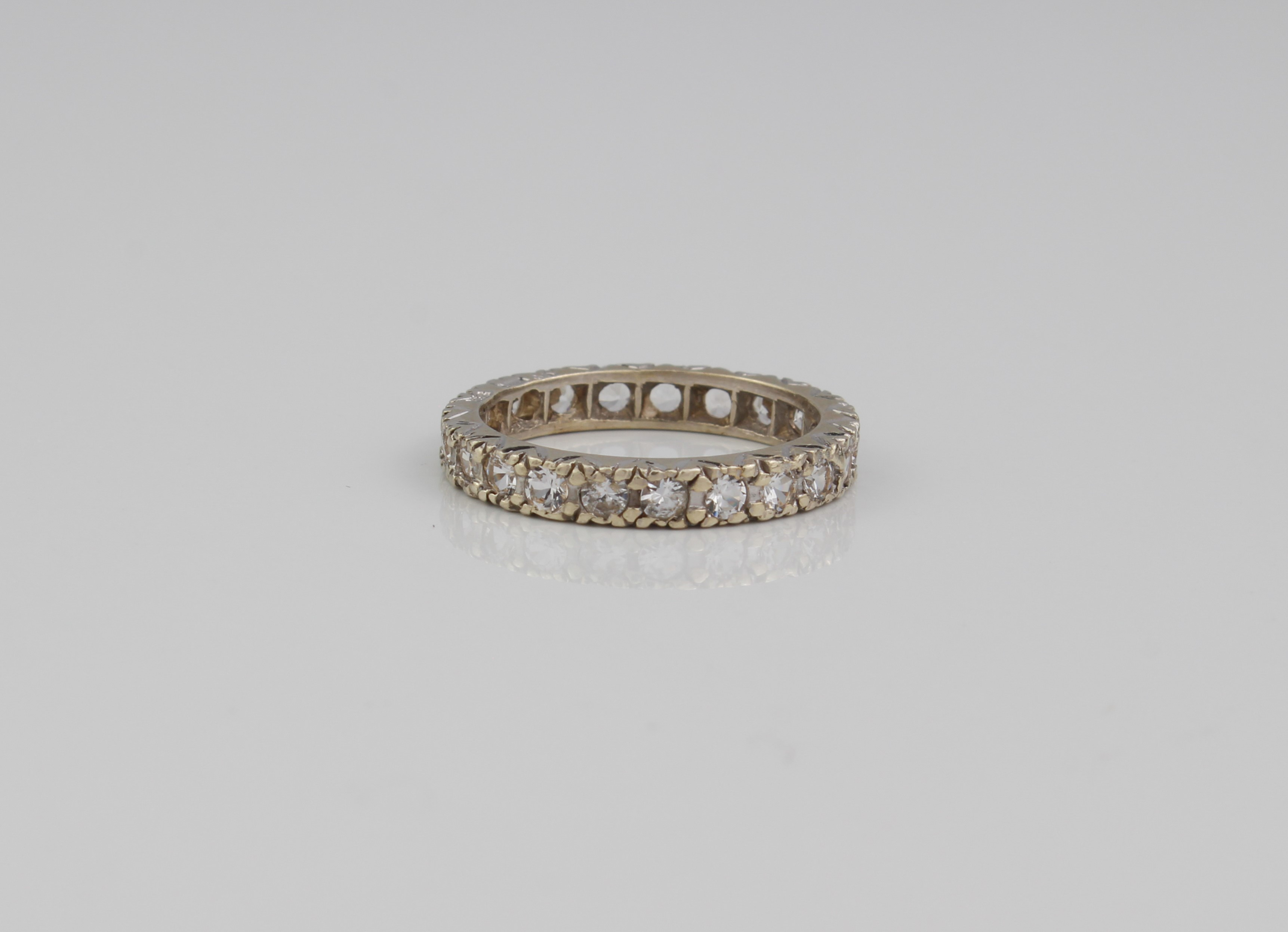 A 9ct white gold full eternity ring - hallmarked London 2004, with 21 round cut white stones, size