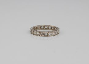 A 9ct white gold full eternity ring - hallmarked London 2004, with 21 round cut white stones, size