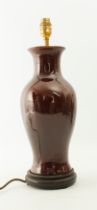 A Chinese-style flambé glaze porcelain vase lamp - of baluster form, in a deep, red-brown glaze,