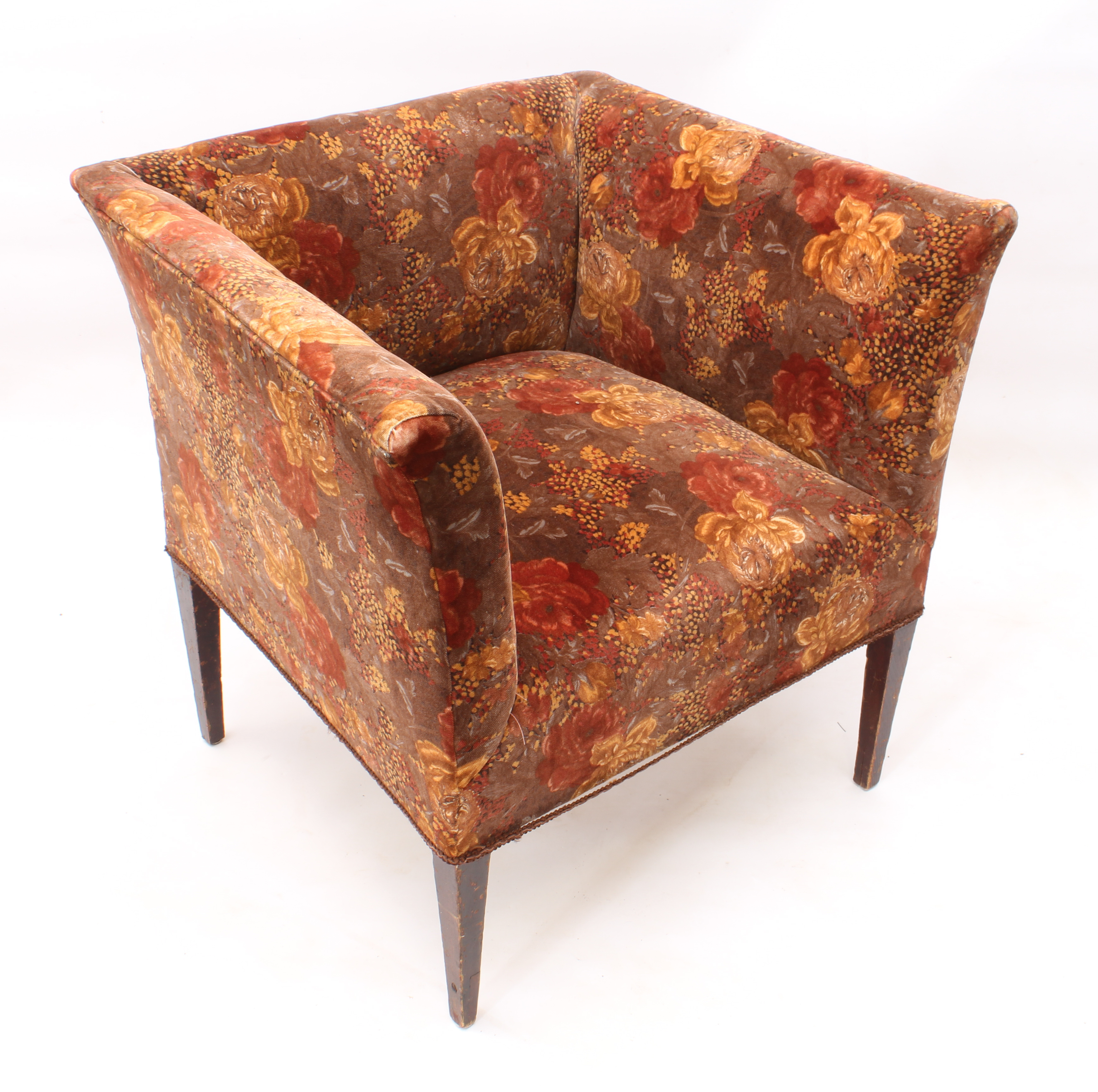 A 1920s angular tub armchair - upholstered in the original floral printed velvet, raised on dark