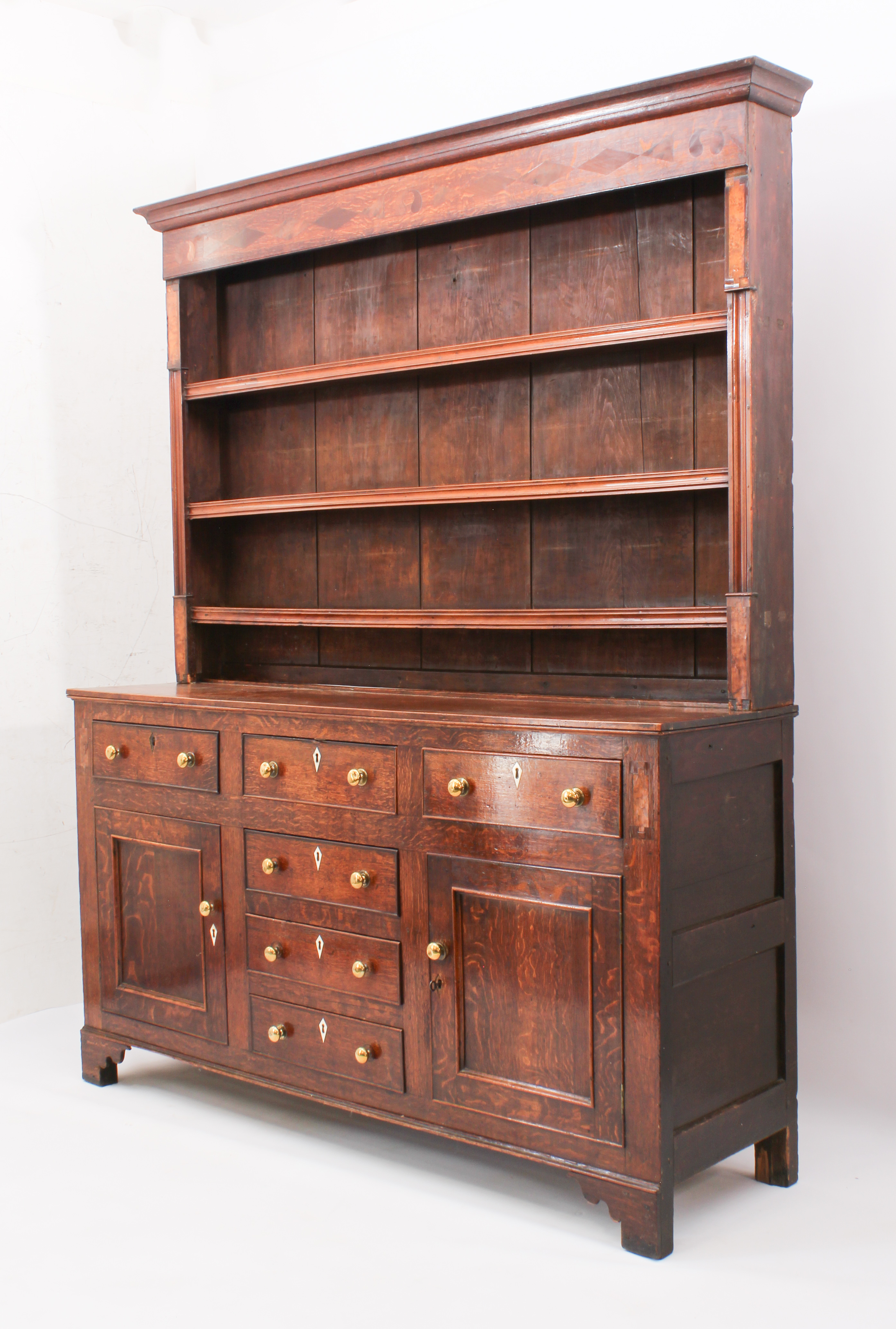 A George III oak, fruitwood and birds' eye maple inlaid dresser - the cavetto cornice over a - Image 2 of 7