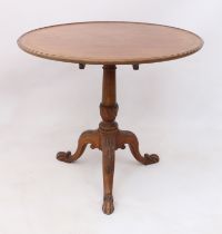 A George III style mahogany tilt-top supper table - early 20th century, the dished circular top on a