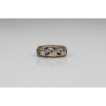 A 9ct gold two-colour sapphire eternity ring - London hallmarks, with alternate round cut white