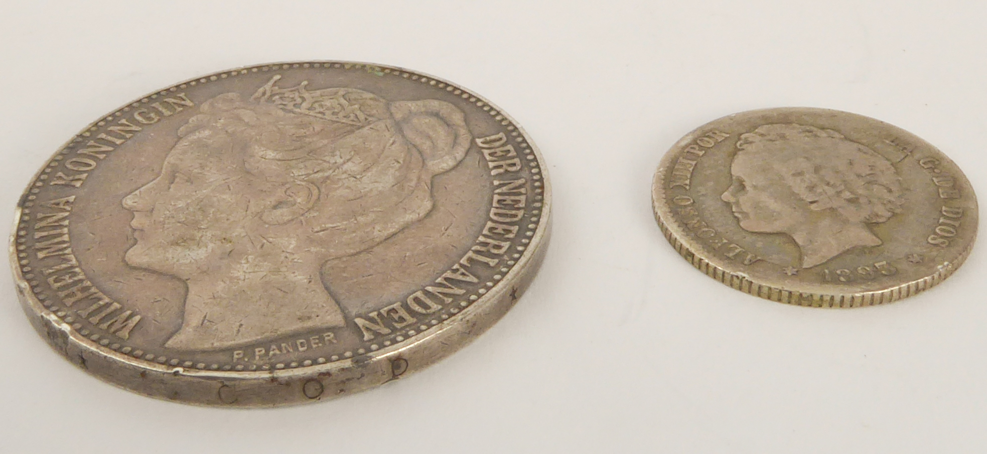 An 1898 silver 2½ gulden (.945) and an 1893 peseta (.835)