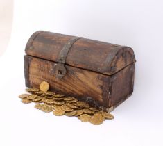 A miniature wooden treasure-chest-style chest - containing 61 gilt-metal gaming counters (23mm in