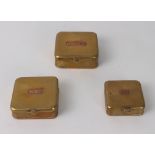 A graduated set of three brass and copper fishing bait boxes - square form with hinged lids,