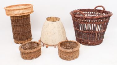 A large wicker two-handled log basket - together with four other wicker baskets and a large copper