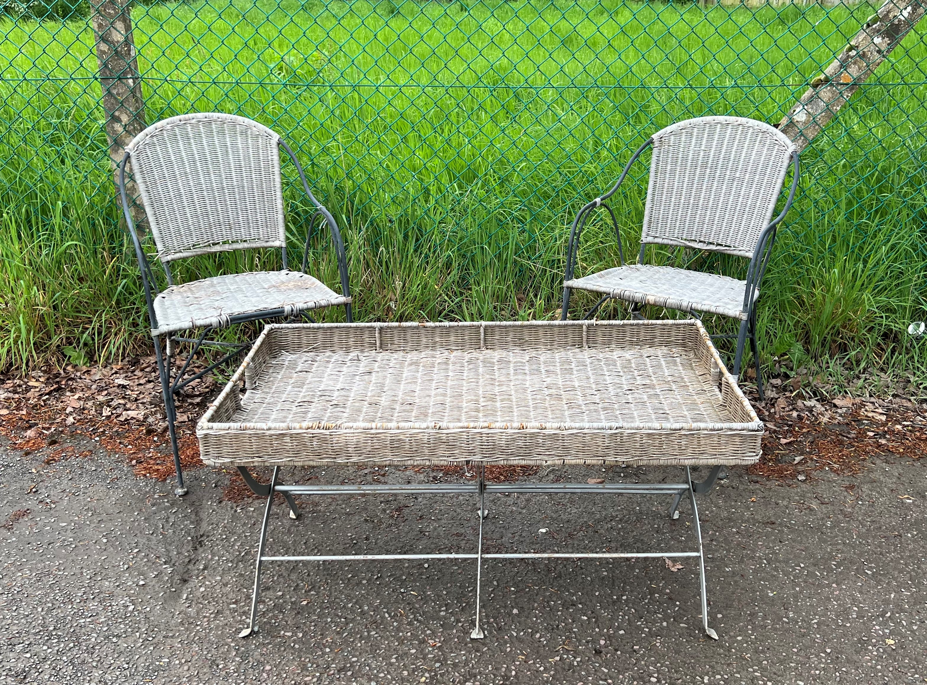 A wrought metal X-frame garden table base with rattan tray - and a pair of wrought metal garden