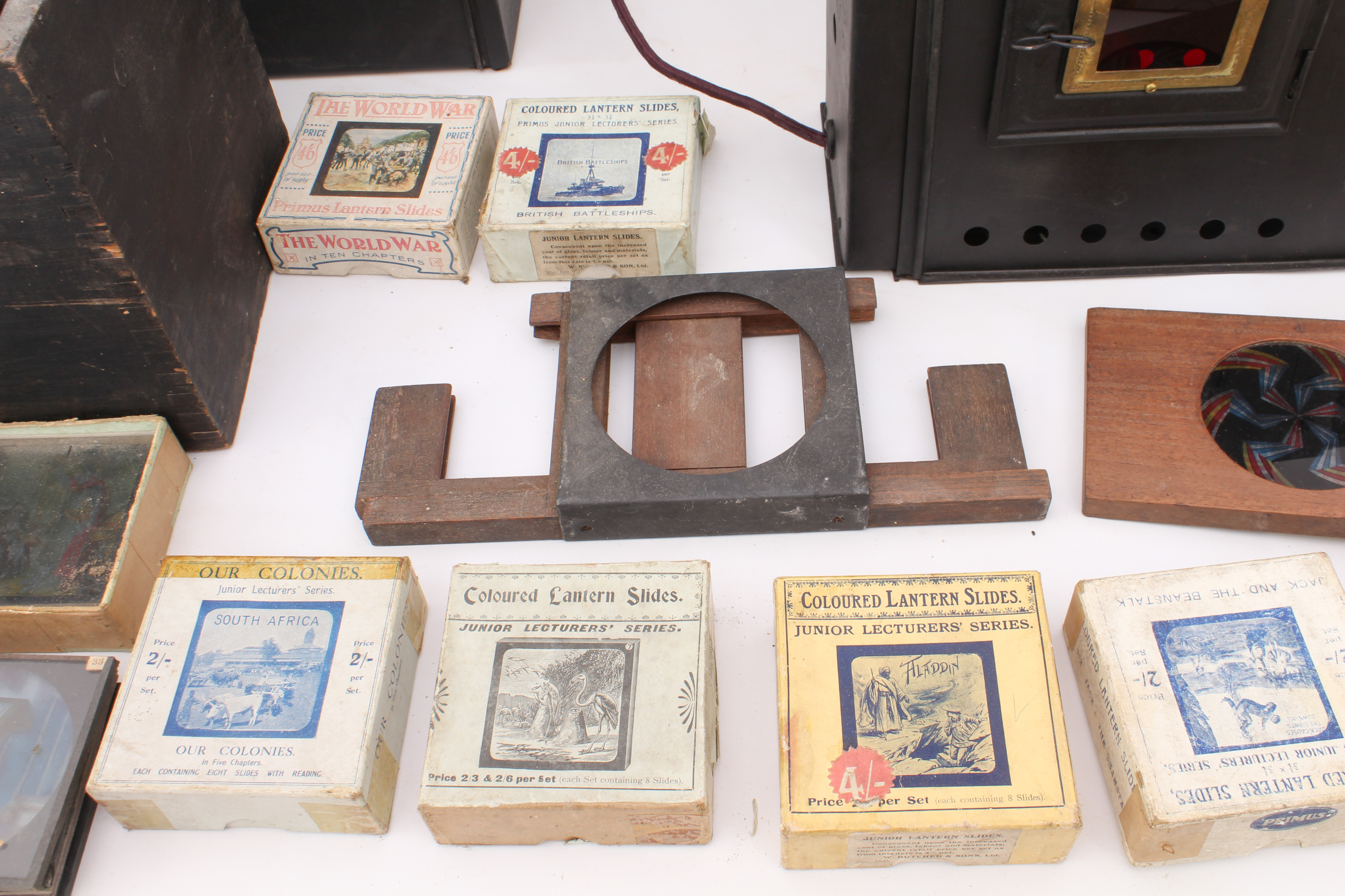 A cased magic lantern and a good quantity of slides to include: a mahogany and gilt-brass hand- - Image 11 of 14