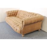 A leather Chesterfield three-seater sofa - modern, in soft pale-brown grained leather, raised on