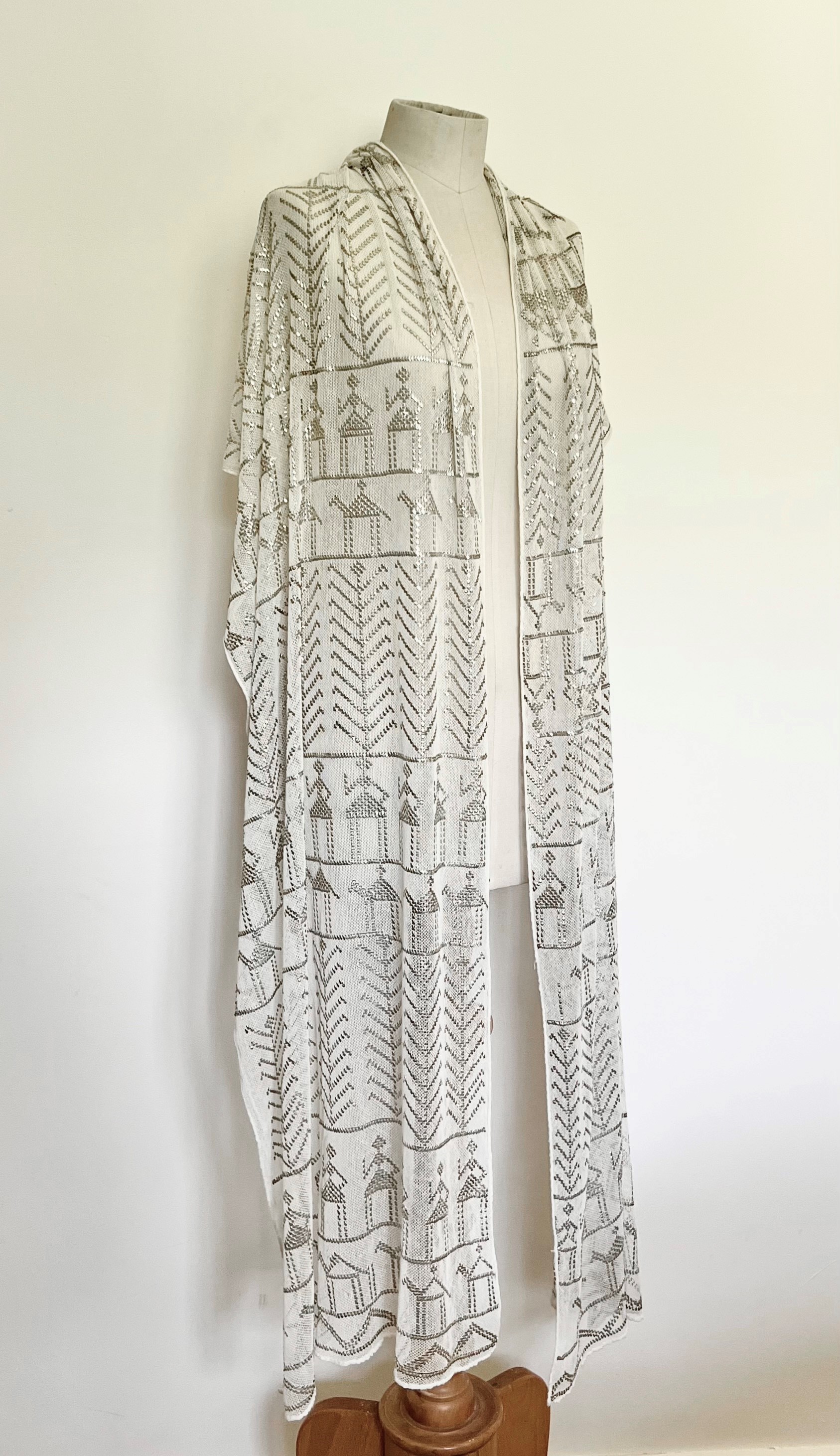 An Egyptian Assuit shawl - mid-20th century, in ivory cotton gauze with decoration of foliage,