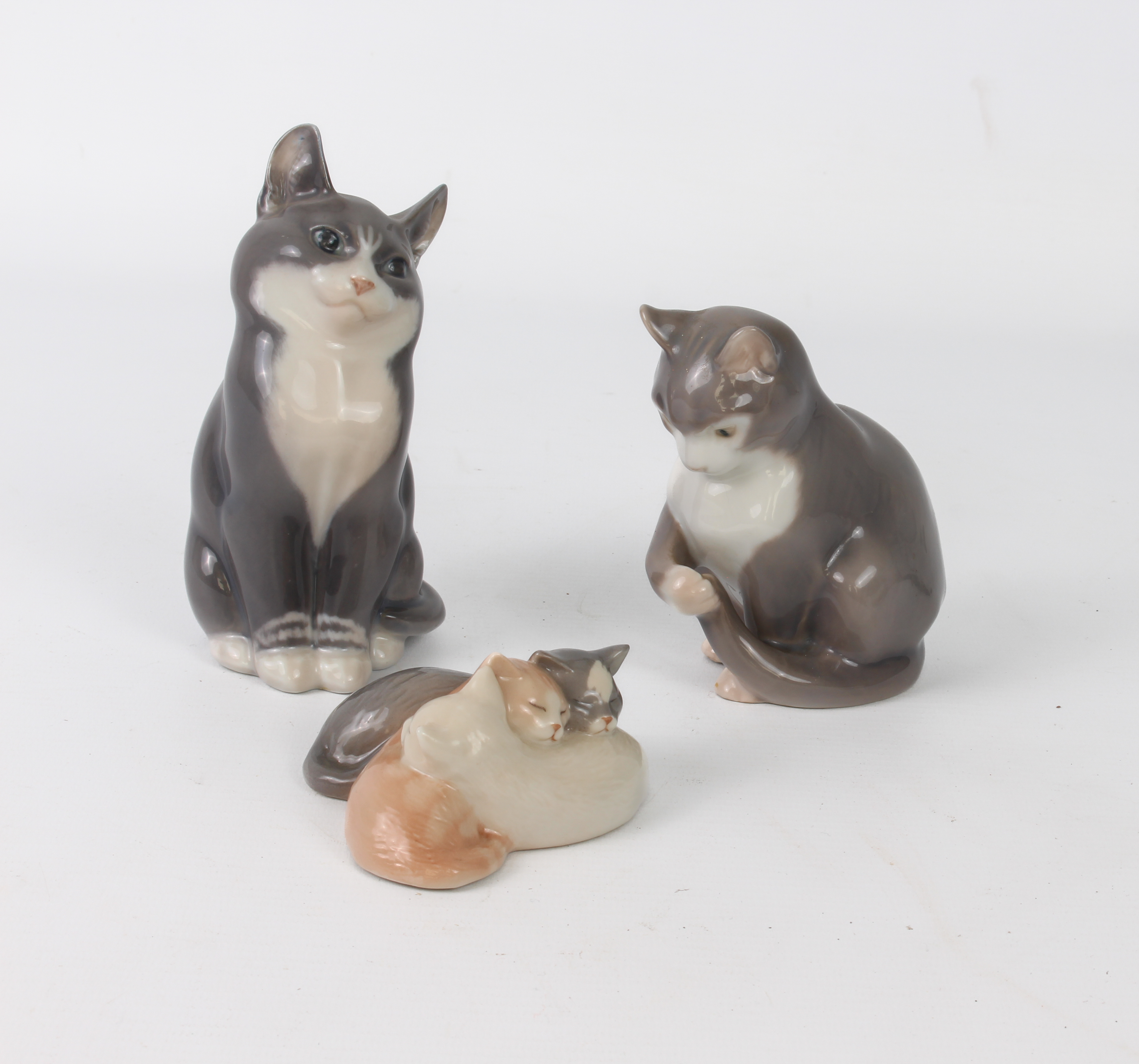 Three porcelain figures of Cats by Royal Copenhagen and Bing & Grondahl - comprising a Royal