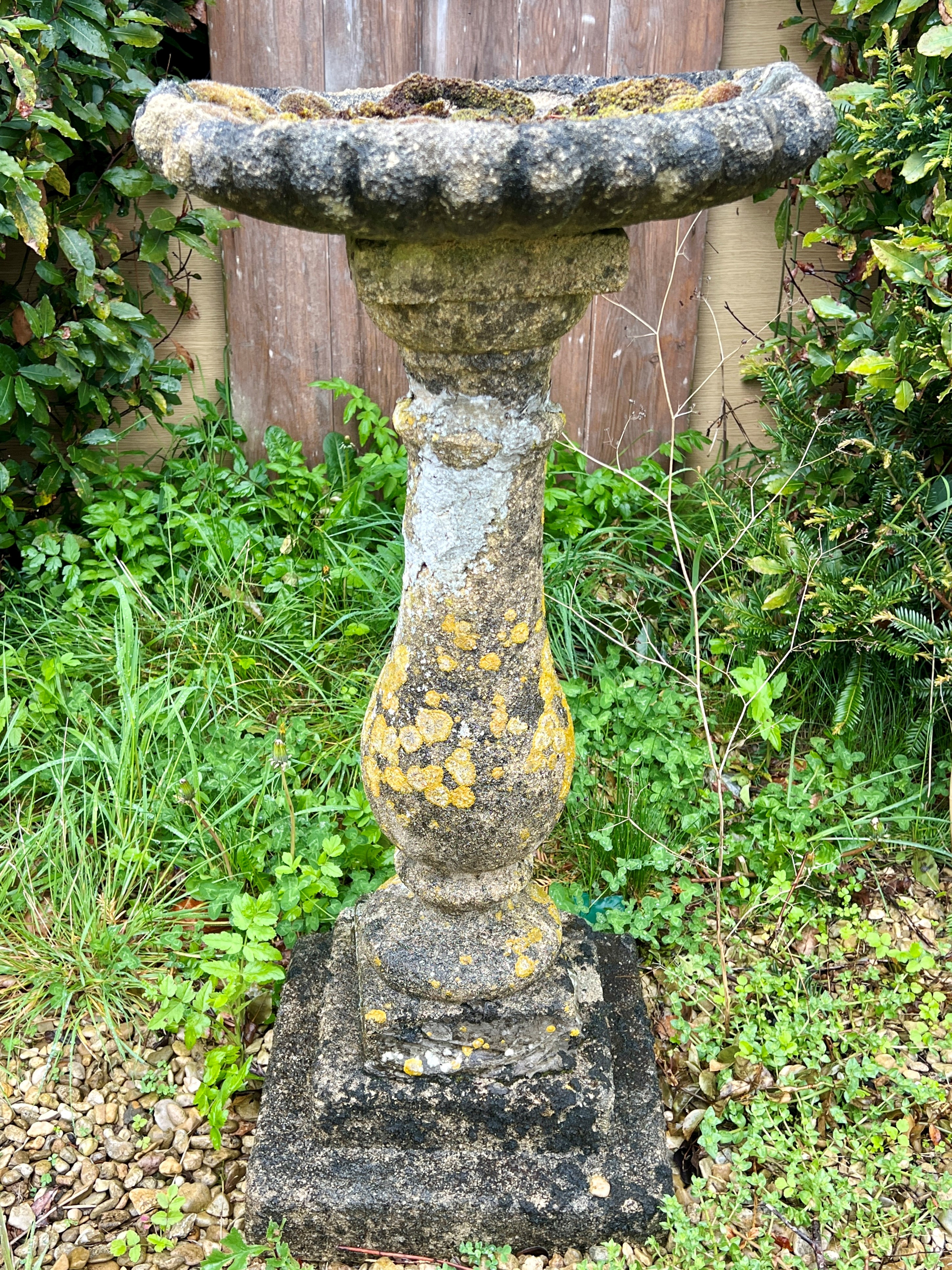 A composite stone bird bath with baluster-shaped pedestal - the bowl 45cm diameter, 87cm high